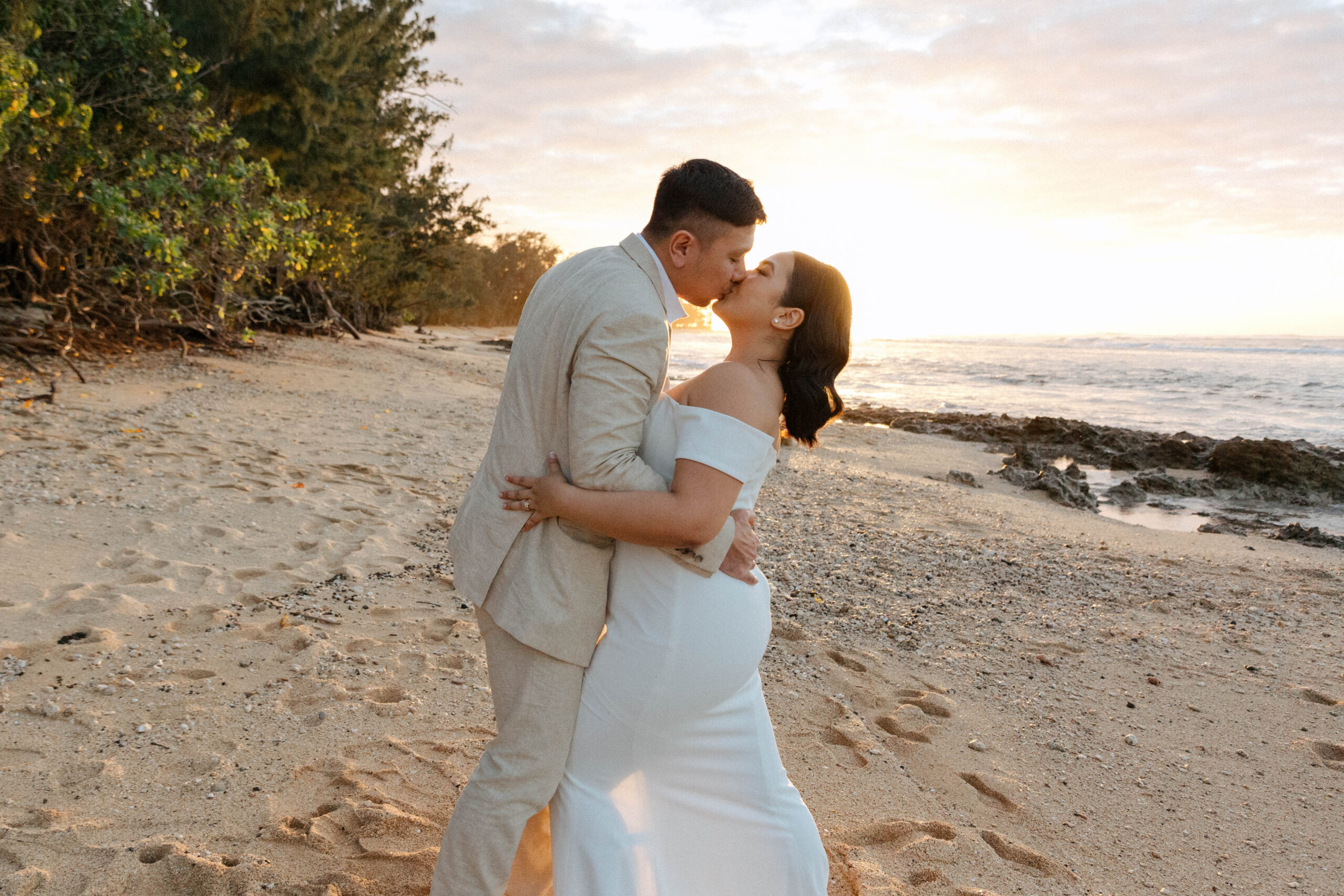 Vasha and Daniel exchange vows on the picturesque shores of Loulu Palm, surrounded by lush greenery and the serene blue waters of Hawaii